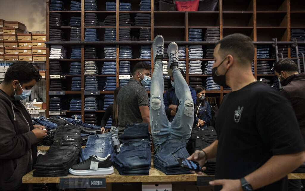 Consumers and workers at a clothing store at a shopping center in the city of Beersheba, southern Israel, Sunday, Feb. 21, 2021. (AP/Tsafrir Abayov) Consumers and workers at a clothing store at a shopping center in the city of Beersheba, southern Israel, Sunday, Feb. 21, 2021. (AP/Tsafrir Abayov)