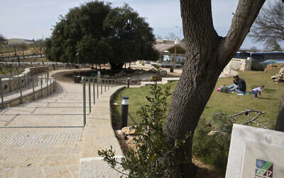 A sign attests that the small promenade was built by the Jewish National Fund, known by its Hebrew acronym KKL, near the Israeli West Bank settlement of Alon Shvut on Feb. 22, 2021. (AP Photo/Sebastian Scheiner)