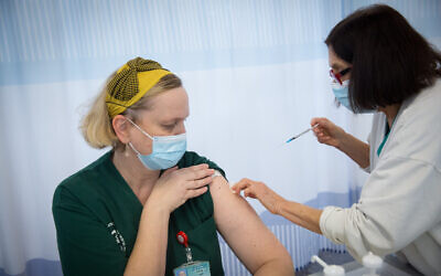 Illustrative: A Sheba staff member receives the second shot of a COVID-19 vaccine at Sheba Medical Center in Ramat Gan, on January 10, 2021. (Miriam Alster/Flash90)