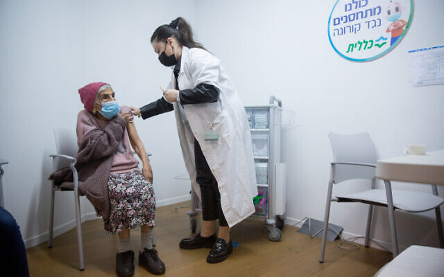 Illustrative: An elderly woman receives a COVID-19 vaccine, at a vaccination center in Tel Aviv, January 21, 2021 (Miriam Alster/Flash90) Illustrative: An elderly woman receives a COVID-19 vaccine, at a vaccination center in Tel Aviv, January 21, 2021 (Miriam Alster/Flash90)