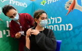 An Israeli student receives a COVID-19 vaccine injection, at a Leumit vaccination center in Tel Aviv, on January 23, 2021. (Avshalom Sassoni/Flash90)