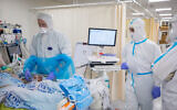 Shaare Zedek hospital team members wearing safety gear as they work in the coronavirus ward on January 27 (Olivier Fitoussi/Flash90)