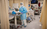 Shaare Zedek hospital team members wearing safety gear as they work in the coronavirus ward of Shaare Zedek hospital in Jerusalem on February 3, 2021, during a 3rd nationawide full lockdown, in an effort to prevent the spread of the Coronavirus. (Yonatan Sindel/Flash90)