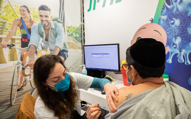 A man receives a Covid-19 vaccine injection, at Clalit Covid-19 vaccination center in Holon, February 4, 2021. (Chen Leopold/Flash90) A man receives a Covid-19 vaccine injection, at Clalit Covid-19 vaccination center in Holon, February 4, 2021. (Chen Leopold/Flash90)