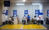 Israelis recieve a COVID-19 vaccine at a Maccabi Health vaccination center at the Givatayim mall, outside of Tel Aviv, February 4, 2021. (Miriam Alster/Flash90)