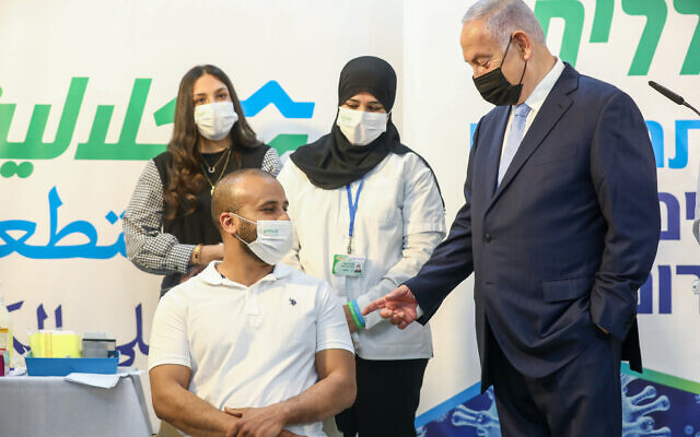 Prime Minister Benjamin Netanyahu (R) during a visit to a COVID-19 vaccination center in Zarzir, northern Israel, February 9, 2021. (David Cohen/Flash90) Prime Minister Benjamin Netanyahu (R) during a visit to a COVID-19 vaccination center in Zarzir, northern Israel, February 9, 2021. (David Cohen/Flash90)