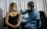 A young Israeli receives a COVID-19 vaccine injection at a vaccination center in Jerusalem, on February 10, 2021.(Yonatan Sindel/Flash90)