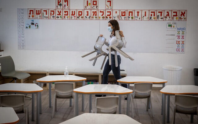 Vered Brosh, the school principal, arranges the class for reopening at "Israeli school Beit Hakerem" in Jerusalem on February 10, 2021. (Yonatan Sindel/Flash90) Vered Brosh, the school principal, arranges the class for reopening at "Israeli school Beit Hakerem" in Jerusalem on February 10, 2021. (Yonatan Sindel/Flash90)