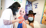 A man receives a COVID-19 vaccine at a vaccination centerl in Safed, on February 14, 2021. (David Cohen/Flash90)
