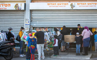 Israelis shop for Purim costumes at a Red Pirate toy store in Kiryat Ekron, ahead of the Jewish holiday of Purim, on February 14, 2021. (Yossi Aloni/FLASH90)