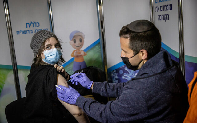An Israeli woman receives a COVID-19 vaccine at a Clalit vaccination center in Jerusalem on February 16, 2021. (Yonatan Sindel/Flash90) An Israeli woman receives a COVID-19 vaccine at a Clalit vaccination center in Jerusalem on February 16, 2021. (Yonatan Sindel/Flash90)