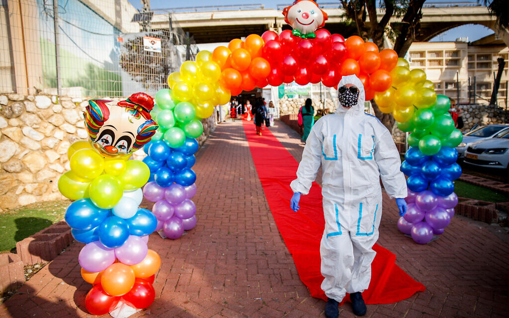 School kids dressed up in costumes arrive to their school ahead of the the Jewish holiday of Purim, in Sderot, southern Israel, on February 24, 2021. (Flash90) School kids dressed up in costumes arrive to their school ahead of the the Jewish holiday of Purim, in Sderot, southern Israel, on February 24, 2021. (Flash90)