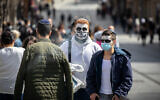 People wearing costumes in Jerusalem on February 24, 2021. (Olivier Fitoussi/Flash90)