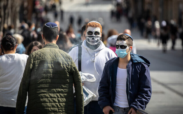 People wearing costumes in Jerusalem on February 24, 2021. (Olivier Fitoussi/Flash90) People wearing costumes in Jerusalem on February 24, 2021. (Olivier Fitoussi/Flash90)