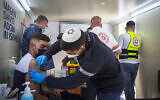 East Jerusalem residents receive COVID-19 vaccine injections in a mobile Magen David Station at the Damascus Gate in the Old City of Jerusalem on February 26, 2021. (Olivier Fitoussi/Flash90)