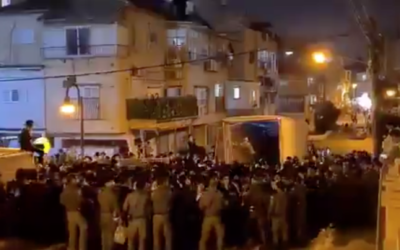 Hundreds pack a street in Bnei Brak for the funeral of Rabbi Chaim Meir Wosner on February 7, 2021. (Screen capture/ Twitter)