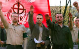Tomasz Greniuch, in the center holding papers, makes a gesture that appears to be a Nazi salute at a far-right event in Poland in 2007. (Bartosz Siedlik, courtesy of Gazeta Wyborcza via JTA)