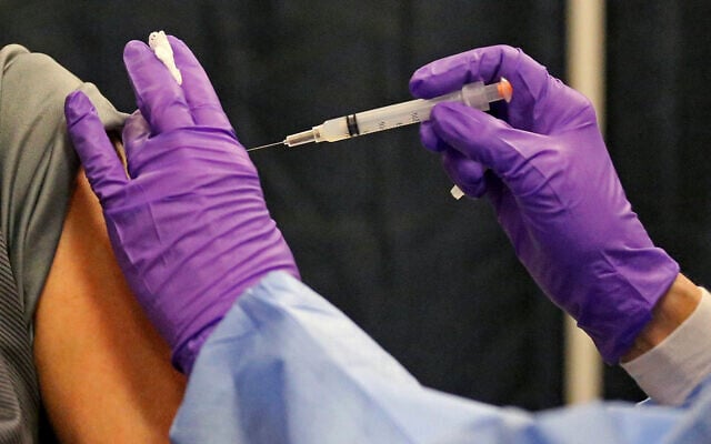 A man gets his COVID-19 vaccine at a mass vaccination site in Natick, Massachusetts, Feb. 24, 2021. (Matt Stone/The Boston Herald via AP, Pool) A man gets his COVID-19 vaccine at a mass vaccination site in Natick, Massachusetts, Feb. 24, 2021. (Matt Stone/The Boston Herald via AP, Pool)