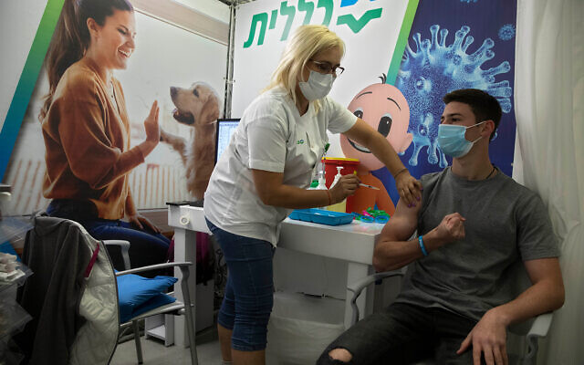 An Israeli youth receives a Pfizer-BioNTech COVID-19 vaccine during an event to encourage the vaccination of young Israelis at a vaccination center in Holon, near Tel Aviv, Feb. 15, 2021. (AP Photo/Sebastian Scheiner) An Israeli youth receives a Pfizer-BioNTech COVID-19 vaccine during an event to encourage the vaccination of young Israelis at a vaccination center in Holon, near Tel Aviv, Feb. 15, 2021. (AP Photo/Sebastian Scheiner)