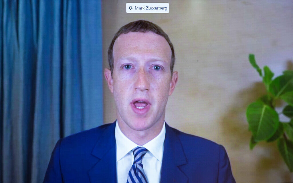 Facebook CEO Mark Zuckerberg appears on a screen as he speaks remotely during a hearing before the Senate Commerce Committee on Capitol Hill in Washington, Oct. 28. 2020. (Michael Reynolds/Pool via AP) Facebook CEO Mark Zuckerberg appears on a screen as he speaks remotely during a hearing before the Senate Commerce Committee on Capitol Hill in Washington, Oct. 28. 2020. (Michael Reynolds/Pool via AP)