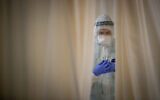 A staff member works in the coronavirus ward of Shaare Zedek hospital in Jerusalem on February 3, 2021. (Yonatan Sindel/Flash90)