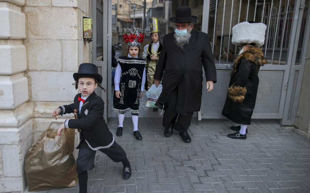 Ultra-Orthodox Jewish children are dressed in costumes to celebrate Purim in Jerusalem's Mea Shearim neighborhood in, on February 25, 2021.
(AHMAD GHARABLI / AFP)
