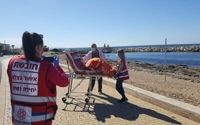 United Hatzalah medics in Nahariya take a Holocaust survivor to the beach, after a trip to a vaccination center. (Courtesy of United Hatzalah)