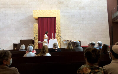 A member of the GIL Jewish community, Karin Rivollet, speaks about Judaism at the GIL synagogue in Geneva, Switzerland, Sept. 6, 2020. (Courtesy of GIL via JTA)