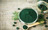 Spirulina tablets and powder (Alexlky via iStock via Getty Images)