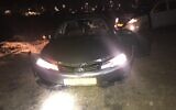 A stolen car that was abandoned inside the Israeli Air Force's Nevatim Base after alleged thieves drove into the facility, puncturing the tires on security spikes at the gate, on February 8, 2021. (Israel Police)