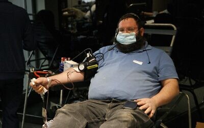 A man donates plasma at the Covid Plasma Initiative's plasma drive at the Jewish Children's Museum, Brooklyn, New York, January 27, 2021. (Courtesy/Anash.org)