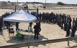 Police officers receive instructions at Nitzanim beach in southern Israel before joining volunteers to help clean up tar from an oil spill, February 22, 2021 (Menachem Fried/Israel Nature and Parks Authority)