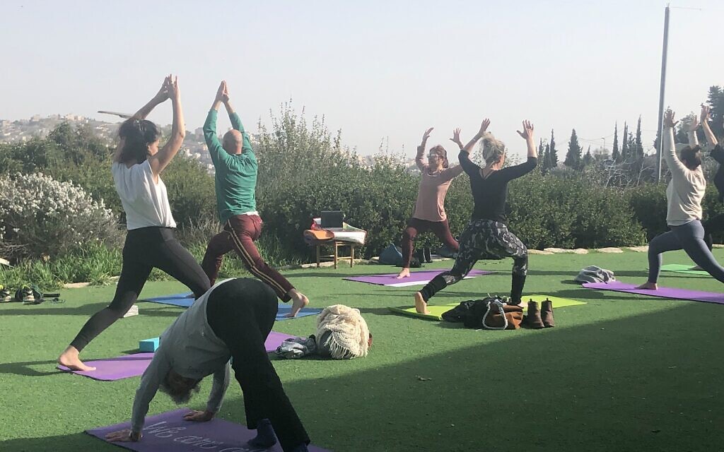Yoga practice with Yoga Synagogue Ah!, a new community founded by Laura Gilinski (center, mauve shirt) during the coronavirus pandemic (Jessica Steinberg/Times of Israel) Yoga practice with Yoga Synagogue Ah!, a new community founded by Laura Gilinski (center, mauve shirt) during the coronavirus pandemic (Jessica Steinberg/Times of Israel)