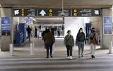 People wearing masks for protection against the coronavirus leave Israel's Ben-Gurion Airport near Tel Aviv, which reopened on March 7, 2021 for a limited number of passengers. (JACK GUEZ / AFP)