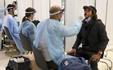 Illustrative: Travelers sit for COVID testing at Ben Gurion Airport on March 8, 2021, upon their arrival from New York. (JACK GUEZ / AFP)