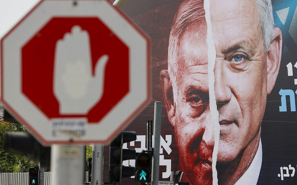 File: An election campaign billboard for Israel's Blue and White opposition party led by Benny Gantz, right, depicting him and Prime Minister Benjamin Netanyahu of the Likud party, hangs in the city of Bnei Brak, on March 14, 2021, ahead of the March 23 general election. The writing in Hebrew reads 'Benny to the Knesset or Bibi forever.' (JACK GUEZ / AFP) File: An election campaign billboard for Israel's Blue and White opposition party led by Benny Gantz, right, depicting him and Prime Minister Benjamin Netanyahu of the Likud party, hangs in the city of Bnei Brak, on March 14, 2021, ahead of the March 23 general election. The writing in Hebrew reads 'Benny to the Knesset or Bibi forever.' (JACK GUEZ / AFP)