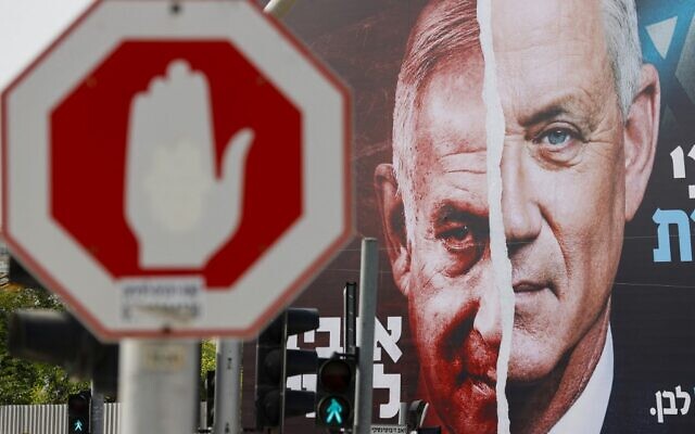 File: An election campaign billboard for Israel's Blue and White opposition party led by Benny Gantz, right, depicting him and Prime Minister Benjamin Netanyahu of the Likud party, hangs in the city of Bnei Brak, on March 14, 2021, ahead of the March 23 general election. The writing in Hebrew reads 'Benny to the Knesset or Bibi forever.' (JACK GUEZ / AFP) File: An election campaign billboard for Israel's Blue and White opposition party led by Benny Gantz, right, depicting him and Prime Minister Benjamin Netanyahu of the Likud party, hangs in the city of Bnei Brak, on March 14, 2021, ahead of the March 23 general election. The writing in Hebrew reads 'Benny to the Knesset or Bibi forever.' (JACK GUEZ / AFP)