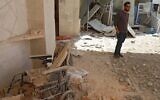 A man stands amid the debris at the entrance of a field hospital in the the village of Atareb in the northern Syrian province of Aleppo on March 21, 2021, after it was reportedly targeted by regime shelling. (AAREF WATAD / AFP)