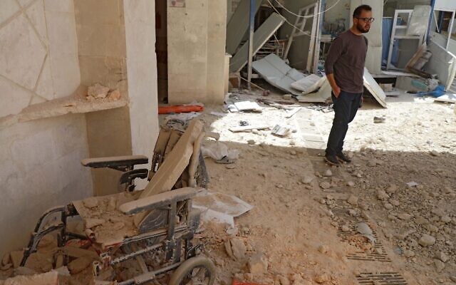 A man stands amid the debris at the entrance of a field hospital in the the village of Atareb in the northern Syrian province of Aleppo on March 21, 2021, after it was reportedly targeted by regime shelling. (AAREF WATAD / AFP) A man stands amid the debris at the entrance of a field hospital in the the village of Atareb in the northern Syrian province of Aleppo on March 21, 2021, after it was reportedly targeted by regime shelling. (AAREF WATAD / AFP)
