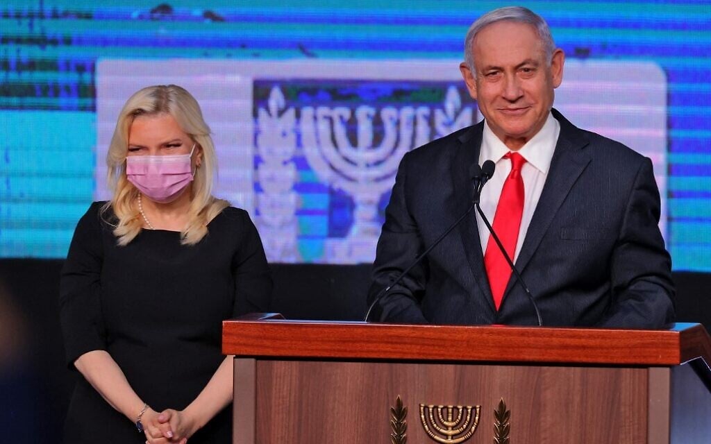 Prime Minister Benjamin Netanyahu and his wife Sara address supporters at  the Likud election party in Jerusalem, early on March 24, 2021, after the end of voting in the fourth national election in two years. (Emmanuel Dunand/AFP)