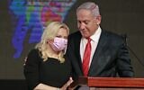 Prime Minister Benjamin Netanyahu with his wife Sara at a Likud post-election gathering early on March 24, 2021, after the end of voting in the fourth national election in two years. (Menahem Kahana / AFP)