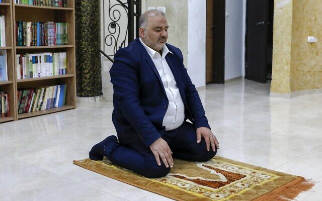 Mansour Abbas, head of the Islamist Ra'am party, prays in the northern town of Maghar on March 26, 2021. (Ahmad Gharabli/AFP)