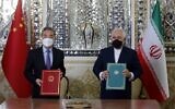 Iranian Foreign Minister Mohammad Javad Zarif (R) and his Chinese counterpart Wang Yi, pose for a picture after signing an agreement in the capital Tehran, on March 27, 2021. Iran and China signed what state television called a "25-year strategic cooperation pact" on today as the US rivals move closer together. (AFP)