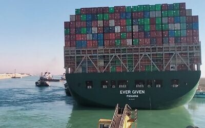 This picture taken on March 29, 2021 from a nearby tugboat in the Suez Canal shows a view of the Panama-flagged MV 'Ever Given' (operated by Taiwan-based Evergreen Marine) container ship as it begins to move. (AFP)