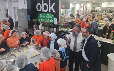 Children cooking at Our Big Kitchen to prepare food for people working to battle devastating flooding. (JTA/ Our Big Kitchen)