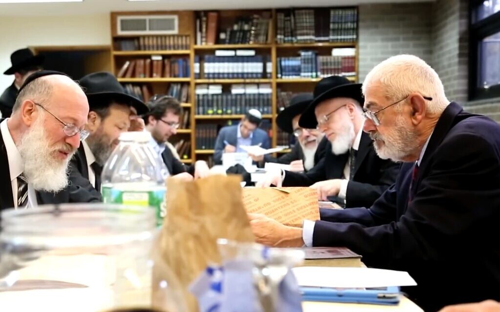 Rabbi Mordechai Willig, left, executes the 2015 sale of hametz to John J. Brown, right. (Josh Weinberg/ screenshot from YouTube/ via JTA) Rabbi Mordechai Willig, left, executes the 2015 sale of hametz to John J. Brown, right. (Josh Weinberg/ screenshot from YouTube/ via JTA)