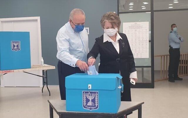 Yisrael Beytenu party leader Avigdor Liberman (L) casting his ballot in Nokdim on March 23, 2021. (Yisrael Beytenu/courtesy)