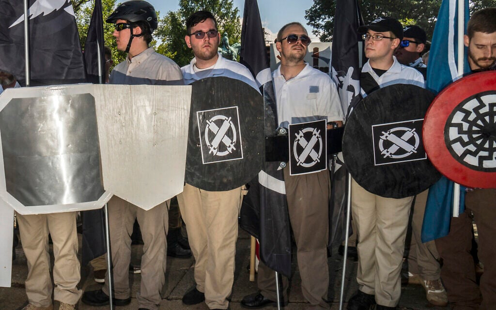 Illustrative: In this August 12, 2017 photo, James Alex Fields Jr., center left, holds a black shield in Charlottesville, Virginia, where a white supremacist rally took place. Fields was later charged with second-degree murder and other counts after authorities say he plowed a car into a crowd of people protesting the white nationalist rally earlier in the day. (Go Nakamura via AP) Illustrative: In this August 12, 2017 photo, James Alex Fields Jr., center left, holds a black shield in Charlottesville, Virginia, where a white supremacist rally took place. Fields was later charged with second-degree murder and other counts after authorities say he plowed a car into a crowd of people protesting the white nationalist rally earlier in the day. (Go Nakamura via AP)