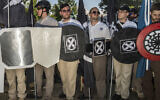 Illustrative: In this August 12, 2017 photo, James Alex Fields Jr., center left, holds a black shield in Charlottesville, Virginia, where a white supremacist rally took place. Fields was later charged with second-degree murder and other counts after authorities say he plowed a car into a crowd of people protesting the white nationalist rally earlier in the day. (Go Nakamura via AP)