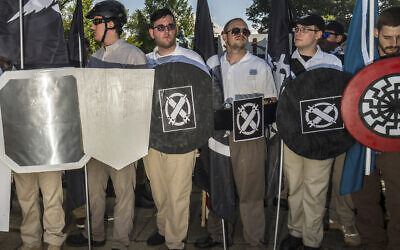 Illustrative: In this August 12, 2017 photo, James Alex Fields Jr., center left, holds a black shield in Charlottesville, Virginia, where a white supremacist rally took place. Fields was later charged with second-degree murder and other counts after authorities say he plowed a car into a crowd of people protesting the white nationalist rally earlier in the day. (Go Nakamura via AP)